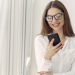 Smiling woman using smartphone